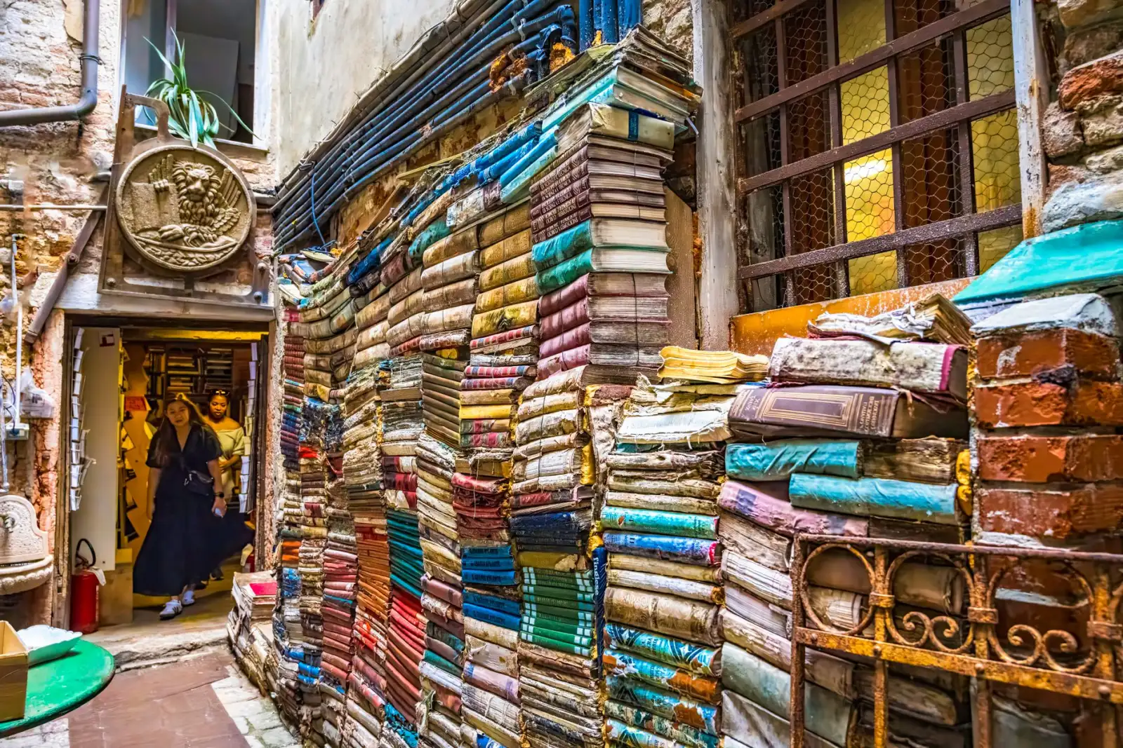 Colourful stacks of books in the Libreria Acqua Alta bookshop in Venice